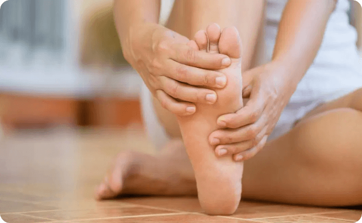 Woman massaging her plantar fasciitis pains