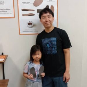 child holding custom insoles